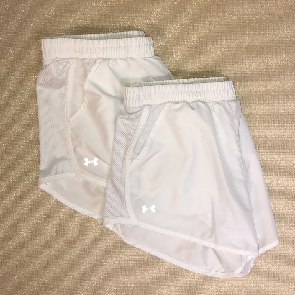 Two pairs of white under armour shorts